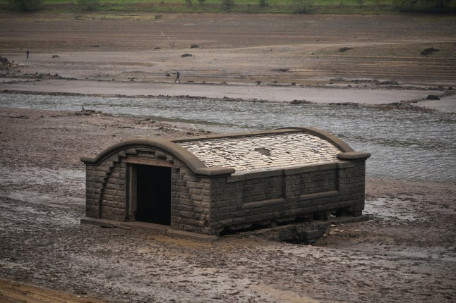 BAMFORD, UNITED KINGDOM - OCTOBER 19: The exposed pump house which provided water to Derwent Village, flooded in the 1940s to provide drinking water for the East Midlands and Sheffield, revealed due to the low water level at Ladybower Reservoir and drought conditions on October 19, 2026 in Bamford, United Kingdom. England is experiencing widespread drought conditions following a record-hot summer and the driest April-to-September period in over a century. Overall, roughly 82% of England remains in drought, 18 reservoir groups are less than half full, and temporary use restrictions remain active across large regions, requiring significant autumn and winter rainfall to replenish severely depleted groundwater and reservoir storage. (Photo by Christopher Furlong/Getty Images)