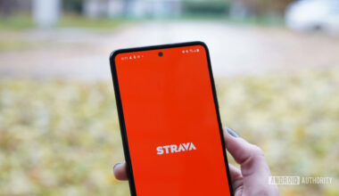 The Strava fitness app home screen is displayed on a Samsung Galaxy A51 on a leaf strewn street.