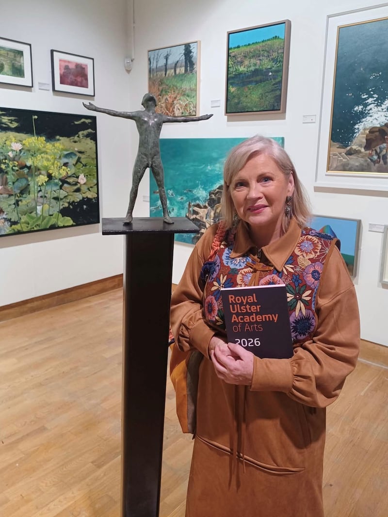 Noelle McAlinden beside Anthony Scott’s Redemption,  one of the exhibits in the 145th Royal Ulster Academy exhibition