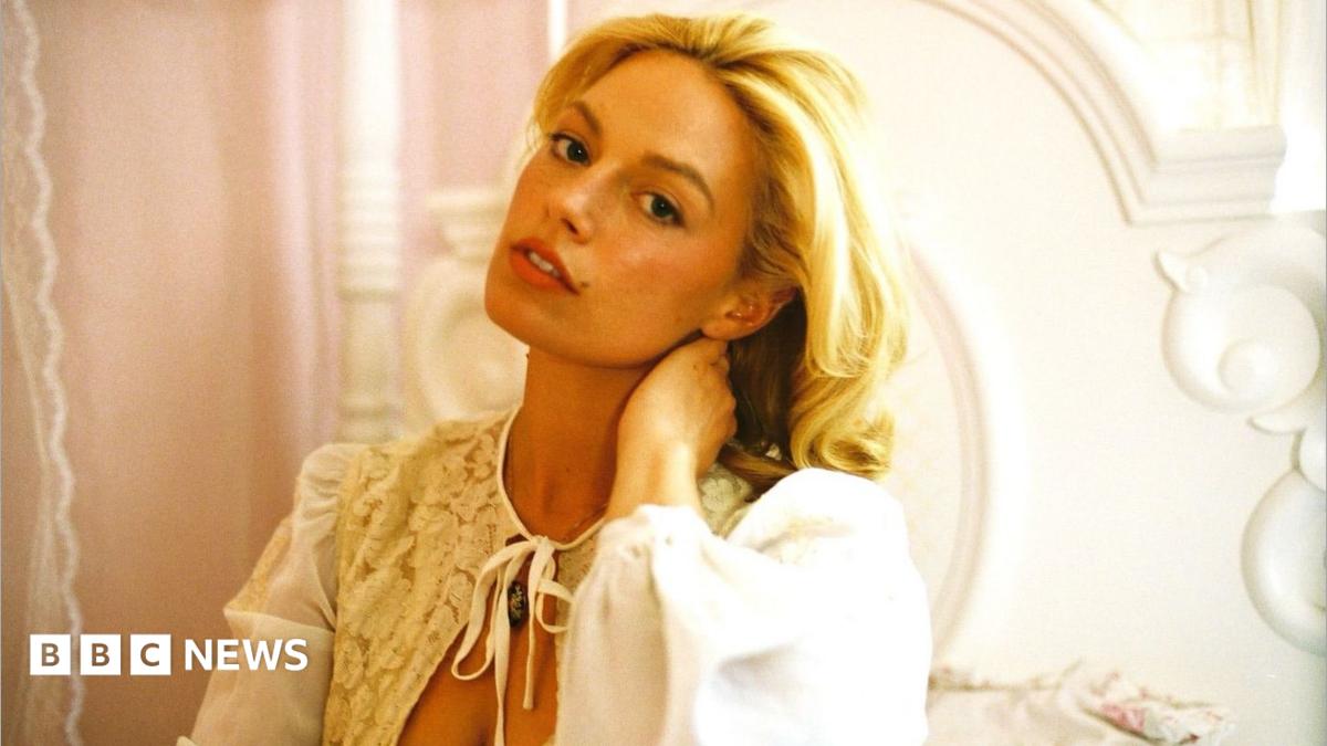 Ashe poses in a wedding dress on the set of her video for Stop The Wedding