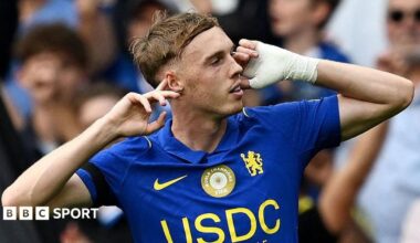 Cole Palmer puts his fingers to his ears after scoring for Chelsea