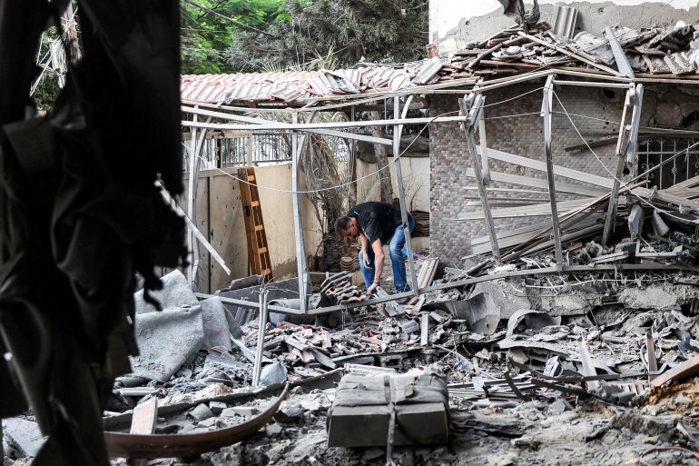 A man inspects debris in a heavily-damaged building following an Israeli strike on a residential apartment in the Rimal neighbourhood of Gaza City early on October 3, 2026.
