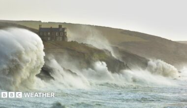 Waves crash against cliffs