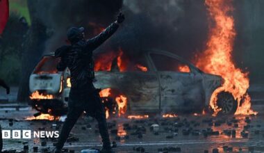 A protester cleaning tear gas from the eyes of another female demonstrator