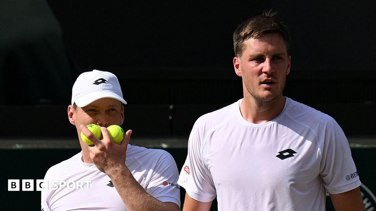Harri Heliovaara and Henry Patten discuss tactics during the Wimbledon men's doubles final in July 2026