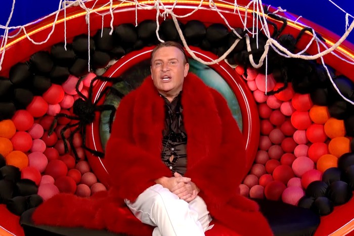 Philip sat in the diary room wearing a large red coat.