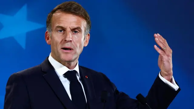 Emmanuel Macron gestures as he speaks during a press conference at a European Union leaders' summit in Brussels