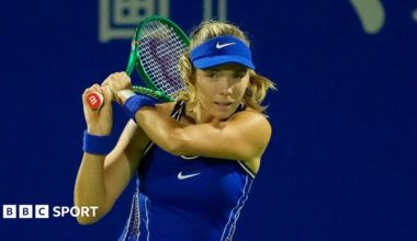 Katie Boulter in a blue outfit and cap, with her racket held near her head after playing a shot