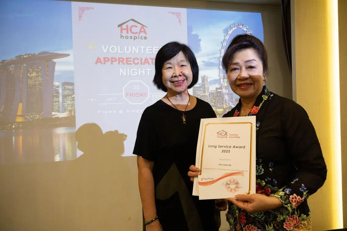 Lim Lean Ee (right) receiving an appreciation award in 2025 for 30 years of volunteer service from HCA Hospice's former chairperson Tan Soh Keng.