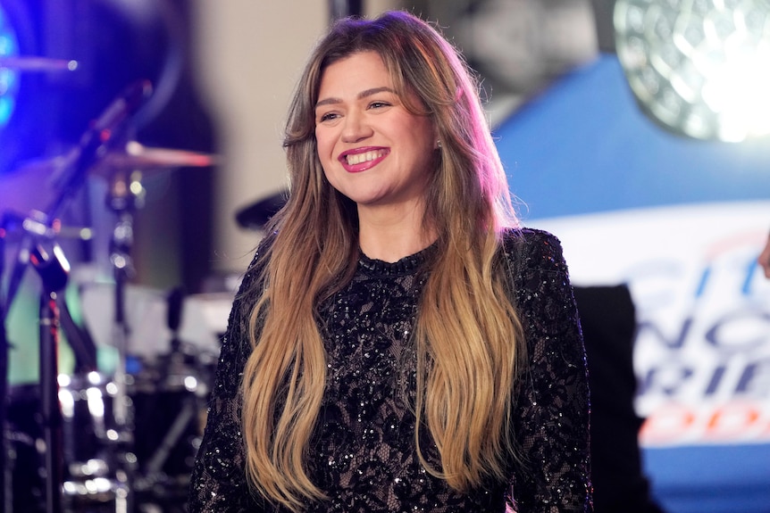 Kelly Clarkson smiling on stage