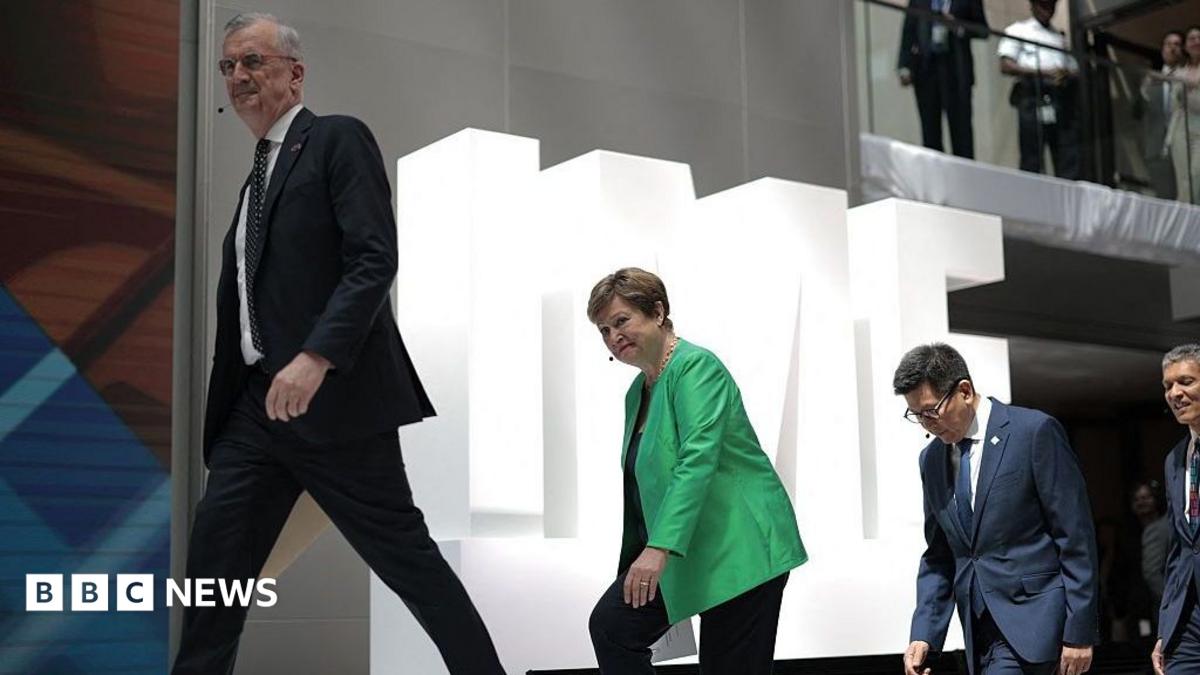 Three people walking up stairs one behind each other against a backdrop of white letters spelling IMF.