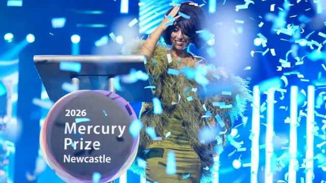 Raye with confetti showering her on stage in Newcastle