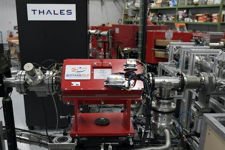 A large piece of machinery, with tubes coming out of it, in a lab workspace