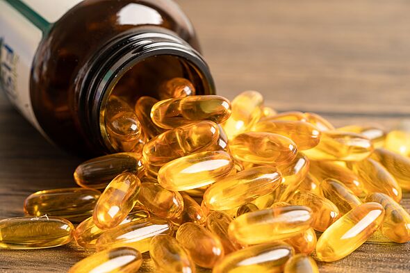 Fish oil Omega 3 capsules vitamin with EPA and DHA isolated on wooden background. Fish oil Omega 3 capsules vitamin with EPA and DHA isolated on wooden background.