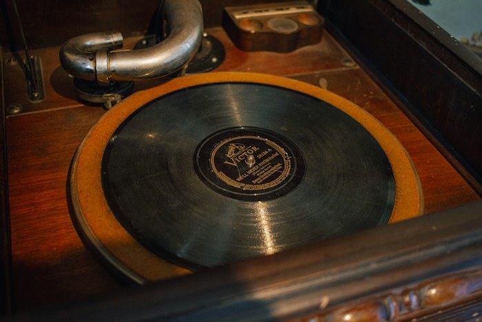 A vintage Victor vinyl record playing on a wooden record player, a rare treasure among dumpster finds.