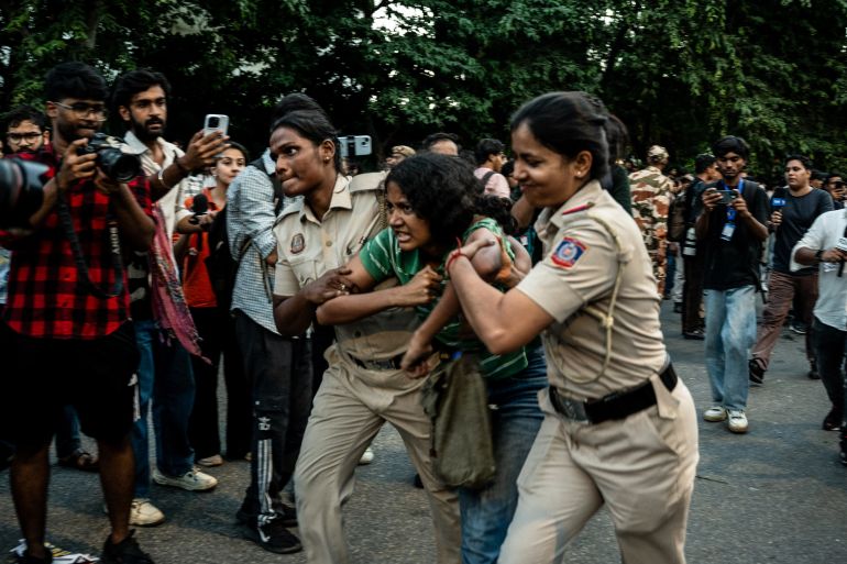 A young protester is detained by police during a demonstration in New Delhi, October 4, 2026