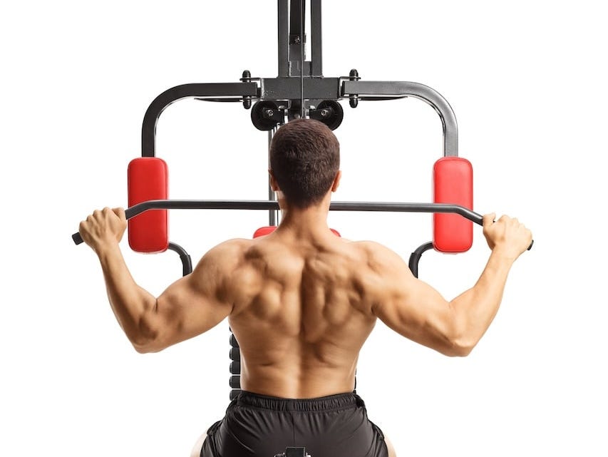 man's muscular back as he performs lat pulldown exercise man's muscular back as he performs lat pulldown exercise