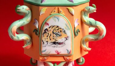 a stylized snuff bottle sculpture made from polymer clay featuring a painting of a small tiger