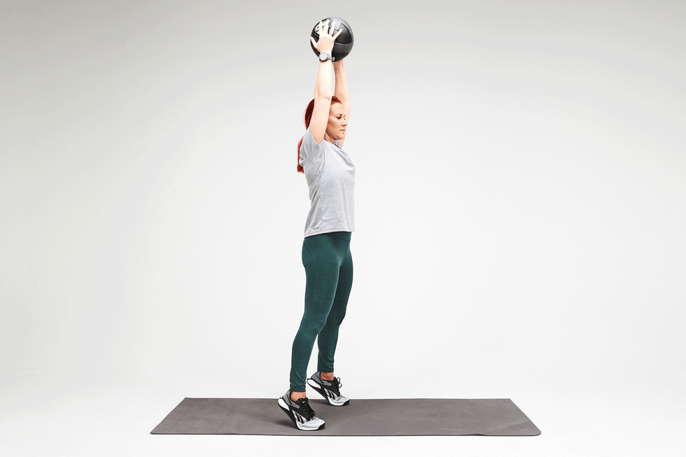 Person performing a weighted overhead exercise person performing a weighted overhead exercise