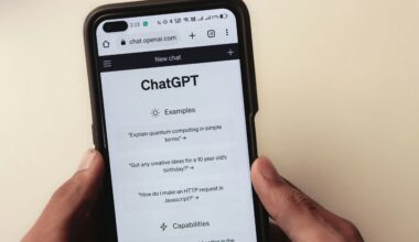 A person holds a cell phone open to a ChatGPT webpage, which is prompting the user to ask a series of questions.