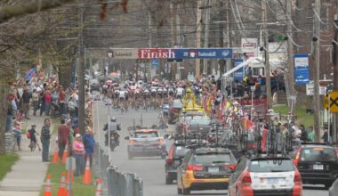 Professional bicycle riders followed by team support cars go through town during the Tour of the Battenkill race on Sunday, April 15, 2012 in Cambridge, NY.