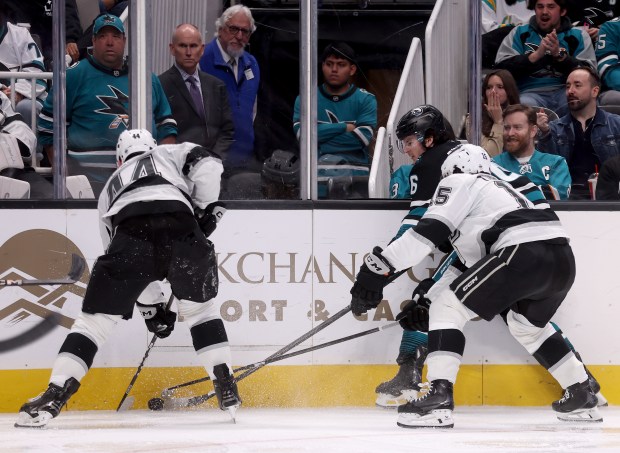 San Jose Sharks’ Sam Dickinson #6 battles for the puck...
