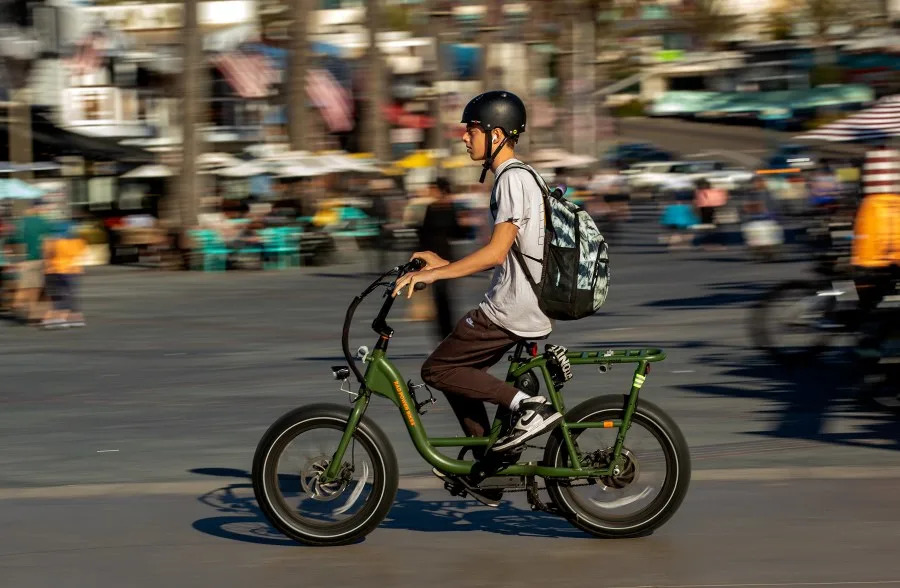 A person rides his e-bike on the Strand in Hermosa Beach. In Hermosa Beach, it's against city code to use electric power on the Strand, but many e-bike riders do so anyway. (Mel Melcon / Los Angeles Times via Getty Images)