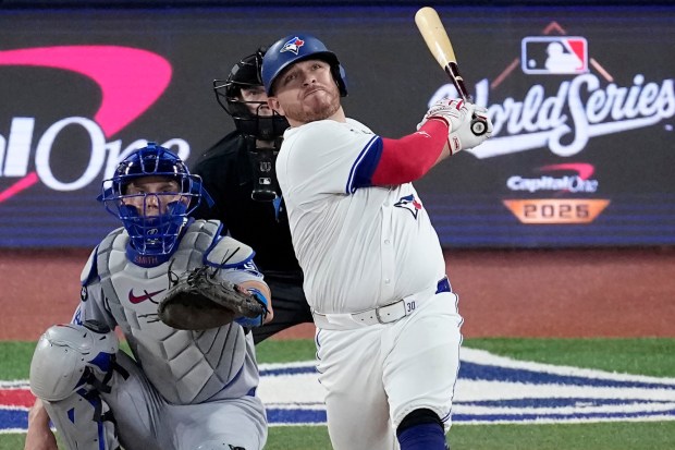 The Toronto Blue Jays' Alejandro Kirk hits a solo home run during the sixth inning of Game 1 of the World Series against the Dodgers on Friday, Oct. 24, 2025, in Toronto. (AP Photo/David J. Phillip)