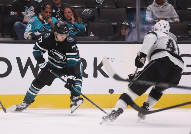 San Jose Sharks’ Michael Misa #77 and Los Angeles Kings’...