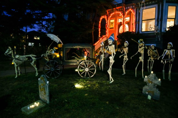 A Halloween display features a funeral procession with musicians ready for the upcoming trick-or-treat night on Paru Street and San Antonio Avenue in Alameda, Calif., on Wednesday, Oct. 26, 2022. (Ray Chavez/Bay Area News Group)