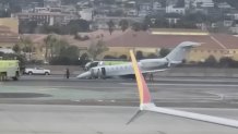 A shot of the small jet on the runway at SAN clearly shows it had a problem with the nose gear.