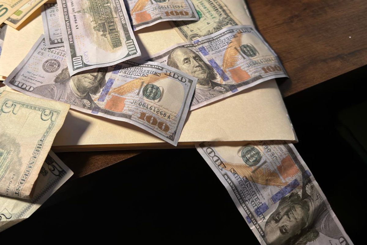 Money drips out of an important folder and off of a table into a dark empty space. The federal government has been losing its capabilities to fund important government research and institutions. “There is no extra money to do anything with at public institutions," said Katherine Jackson, a Clinical Director at University of California, San Francisco Benioff Hospital.