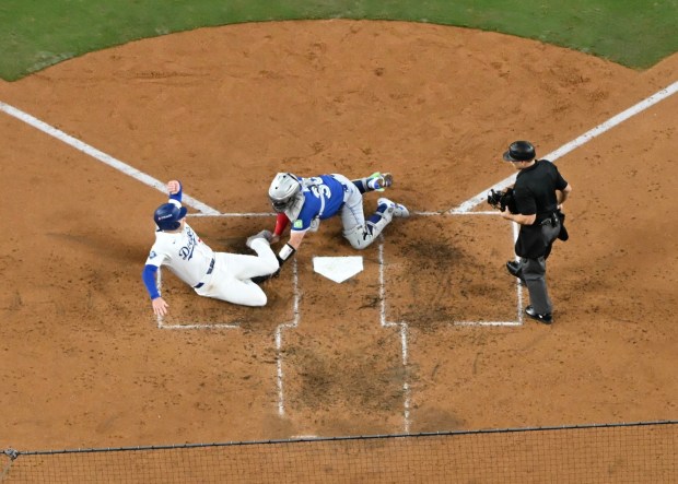 Toronto Blue Jays catcher Alejandro Kirk, right, tags out the Dodgers' Freddie Freeman as he tries to score during the third inning of Game 3 of the World Series on Monday, Oct. 27, 2025, at Dodger Stadium. (Photo by Keith Birmingham, Pasadena Star-News/SCNG)