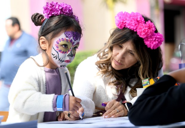 Emery Perez, 6, and her grandma Gabriela Neufeld work on...