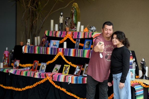 Sergio Imbler takes a selfie with Aeris Pulos, 11, in...