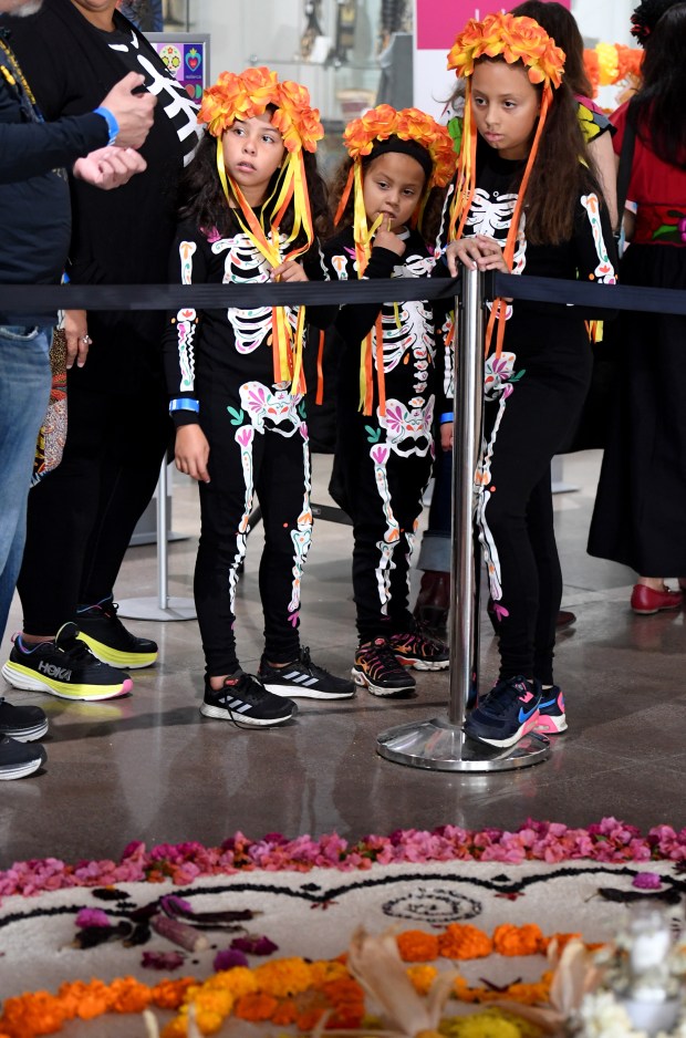 Sisters Idanya, left, Aziza, and Ezrah Brown-Najero attend Día de...