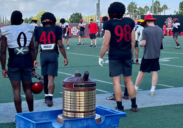 The Old Oil Can Trophy on the sideline during Wednesday's workout on the SDSU practice field. (Kirk Kenney / San Diego Union-Tribune)