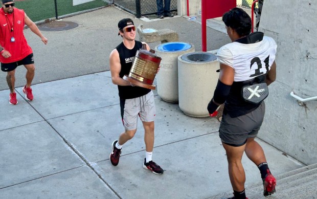San Diego State linebacker Tano Letuli approaches The Old Oil Can Trophy on Wednesday as he walks down to the SDSU practice field. (Kirk Kenney / San Diego Union-Tribune)