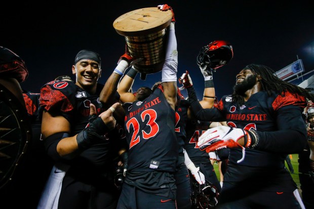 SDSU cornerback Darren Hall (23) drinks from the Old Oil Can after the Azttecs' 2019 victory over Fresno St. Photo by Chadd Cady, The San Diego Union-Tribune