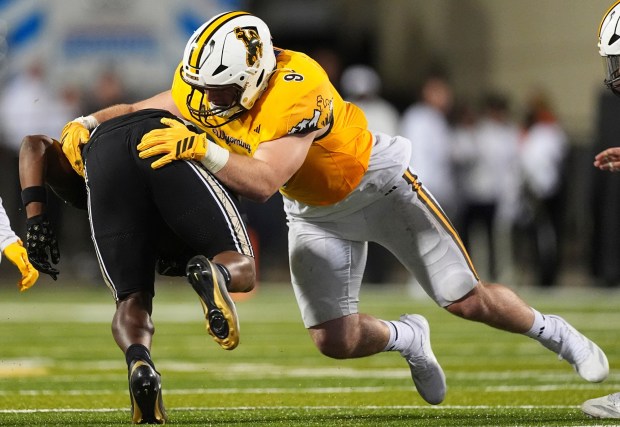 Wyoming linebacker Brayden Johnson (9) stops Colorado running back Micah Welch (29) in the second half of an NCAA college football game Saturday, Sept. 20, 2025, in Boulder, Colo. (AP Photo/David Zalubowski)