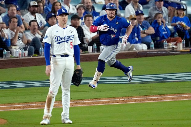 Toronto Blue Jays' Alejandro Kirk watches his three run home run leave the park as Los Angeles Dodgers' Freddie Freeman (5) looks on during the fourth inning in Game 3 of baseball's World Series, Monday, Oct. 27, 2025, in Los Angeles. (AP Photo/David J. Phillip)