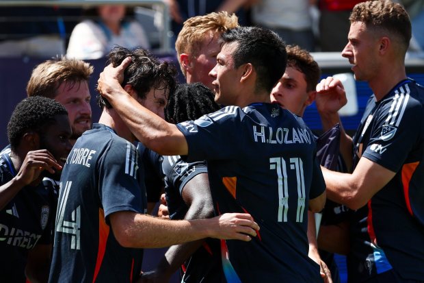 San Diego FC midfielder Luca De La Torre (14) and midfielder Hirving Lozano (11) celebrate with teammates after a goal against the Los Angeles Galaxy during their match at Snapdragon Stadium on Saturday, May 24, 2025 in San Diego, CA. (Meg McLaughlin / The San Diego Union-Tribune)