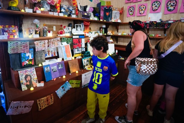 Malakai McCray, 8, who had his own artwork on display, looked over several other pieces of art with his mother, Kendra Bowen, of Chula Vista.  Hundreds of artworks from students from 30 schools in the San Diego Unified School District, in grades TK to 12th grade, were on display to honor Dia de los Muertos in Old Town State Historic Park.