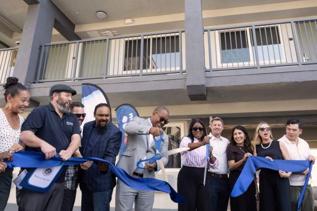 From left, Mayor Rex Richardson and Councilwoman Tunua Thrash-Ntuk celebrate...