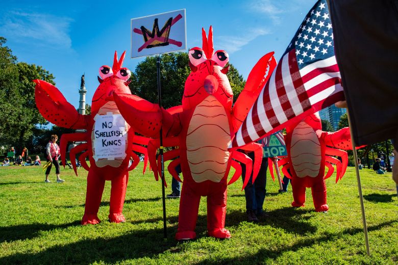 People in lobster costumes participate in Boston protest on Saturday.