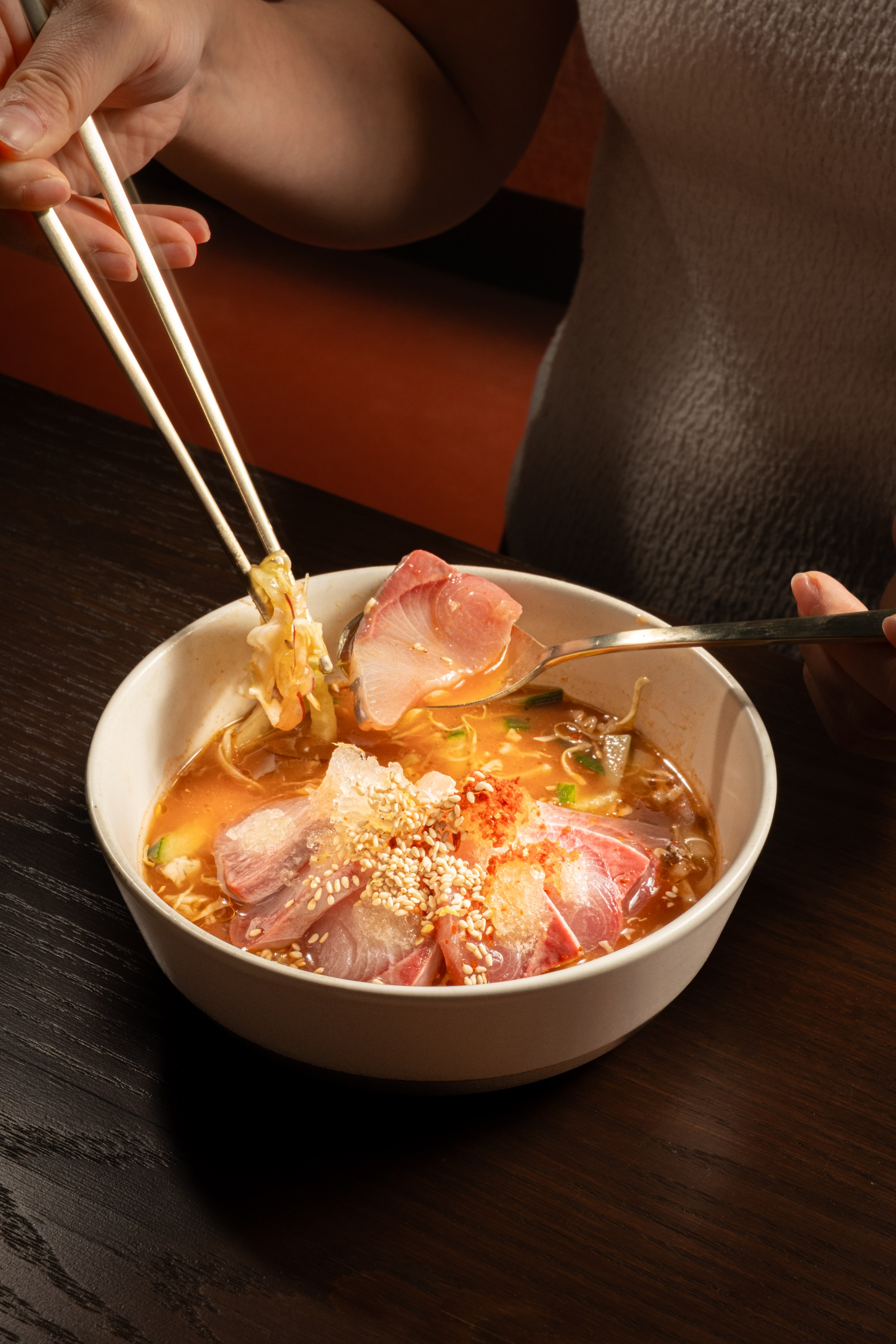 Mulhwe with yellowtail and broth with chopsticks digging in