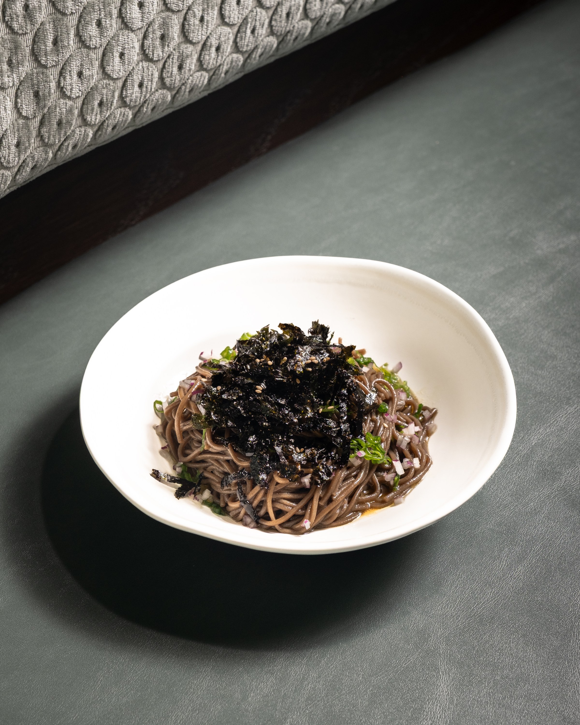Buckwheat noodle with perilla oil in a white bowl at Hojokban