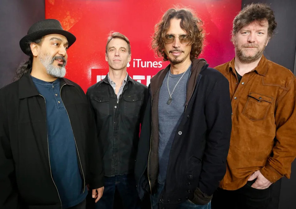 Soundgarden members Kim Thayil, Matt Cameron, Chris Cornell and Ben Shepherd standing in a line, posing for photo
