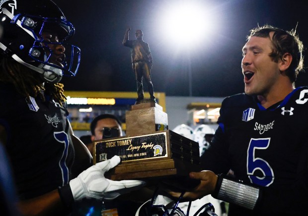San Jose State's Xavier Ward (7) and San Jose State's quarterback Walker Eget (5) hold the Tomey Legacy Trophy after winning against Hawaii at CEFCU Stadium in San Jose, Calif., on Saturday, Nov. 1, 2025. (Shae Hammond/Bay Area News Group)