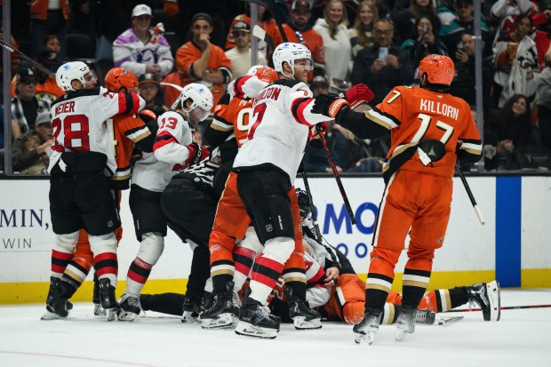 Ducks and New Jersey Devils players fight during the third...
